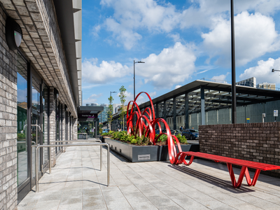 Exterior of hotel with red metal bench/sculpture Exterior of hotel with red metal bench/sculpture