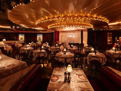 Interior of Louis, Manchester with dining tables and chairs under circular lighting Interior of Louis, Manchester with dining tables and chairs under circular lighting