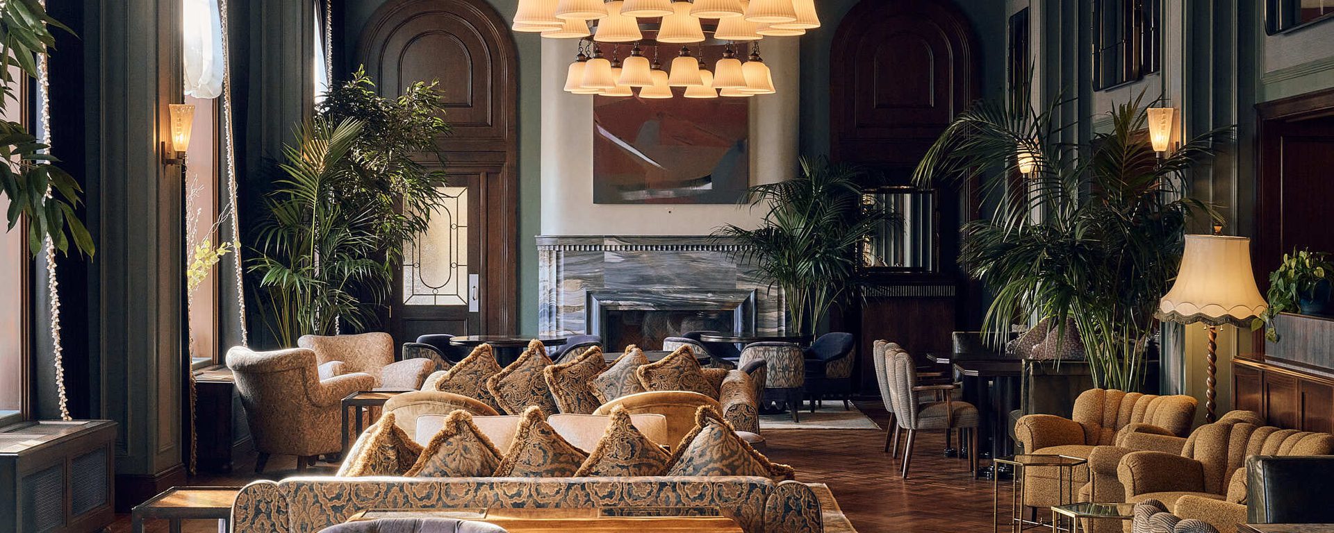 Lounge area with sofas, tables and chairs with large ceiling lights Lounge area with sofas, tables and chairs with large ceiling lights