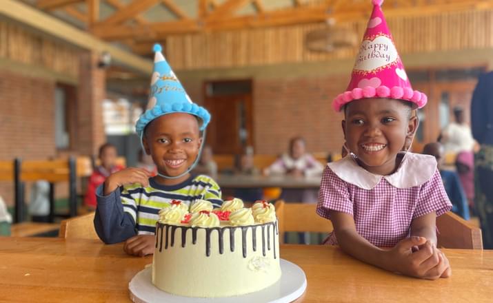 Two children smiling and celebrating a 4th birthday