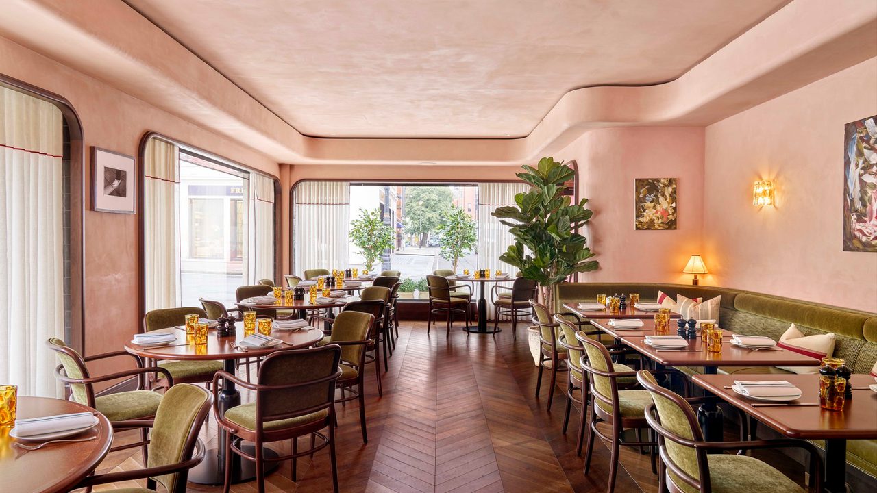 Tables and chairs in restaurant next to large floor to ceiling windows Tables and chairs in restaurant next to large floor to ceiling windows