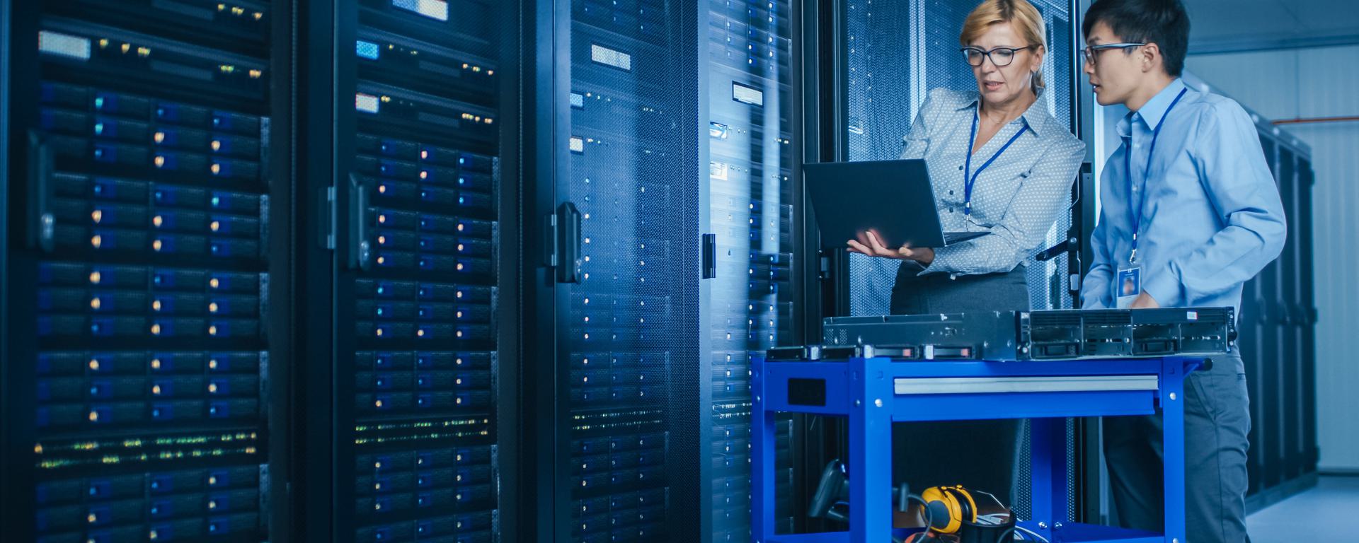 IT engineers installing new hardware on server racks IT engineers installing new hardware on server racks