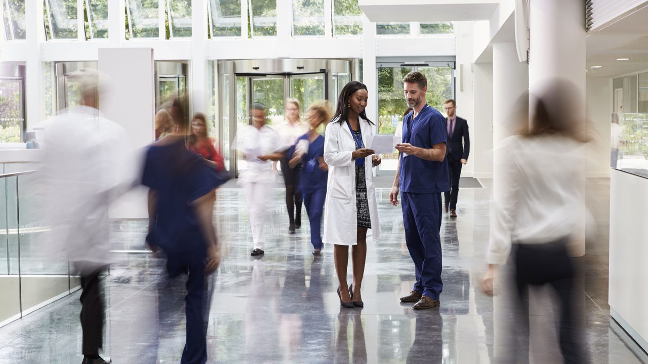 Staff in busy reception area of a modern hospital Staff in busy reception area of a modern hospital