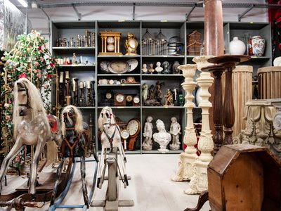 National Theatres stores with rocking horses, columns and shelves of associated clocks, plaster busts etc National Theatres stores with rocking horses, columns and shelves of associated clocks, plaster busts etc