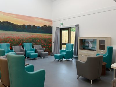 Ruby Ward - new lounge area with large photograph on wall with field full of poppies Ruby Ward - new lounge area with large photograph on wall with field full of poppies
