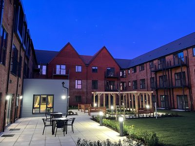 Sandstone Court - rear gardens with pergola, patio area with seating and lawn Sandstone Court - rear gardens with pergola, patio area with seating and lawn