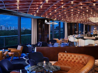 The Peninsula London - interior of bar area at night time with views over London The Peninsula London - interior of bar area at night time with views over London