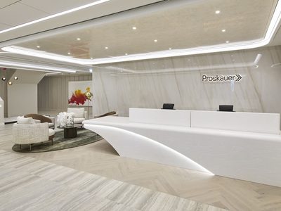 Large white reception desk and stairs to upper levels Large white reception desk and stairs to upper levels