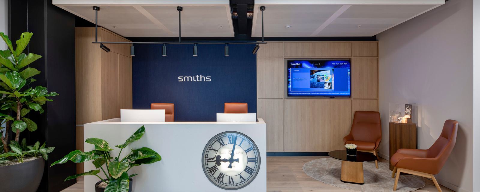 Reception area with large clock on front of reception desk