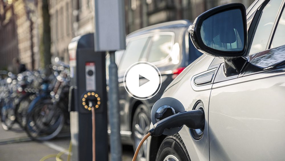 Electric vehicle plugged into charger