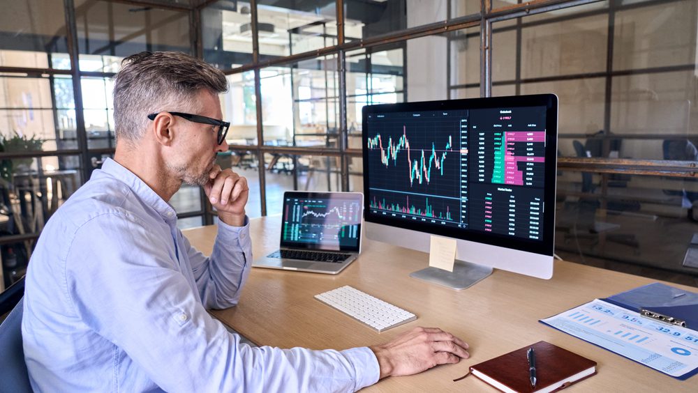 Man seated at computer looking at screen